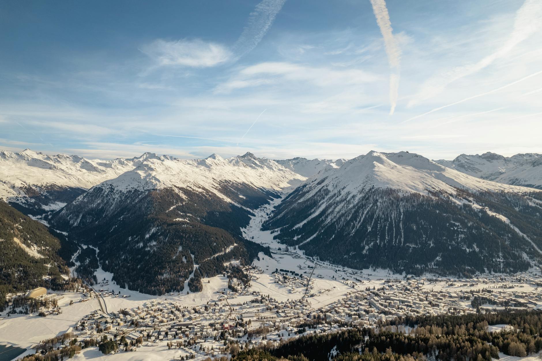 A breathtaking winter view of snow-covered mountains and village in Klosters-Serneus, Switzerland.