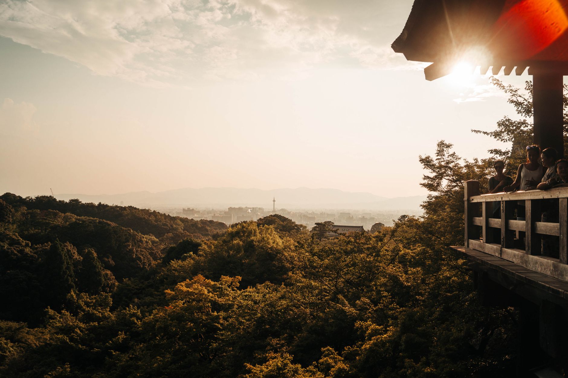Breathtaking sunset view over Kyoto from Kiyomizu-dera Temple, capturing golden hues and a serene landscape.