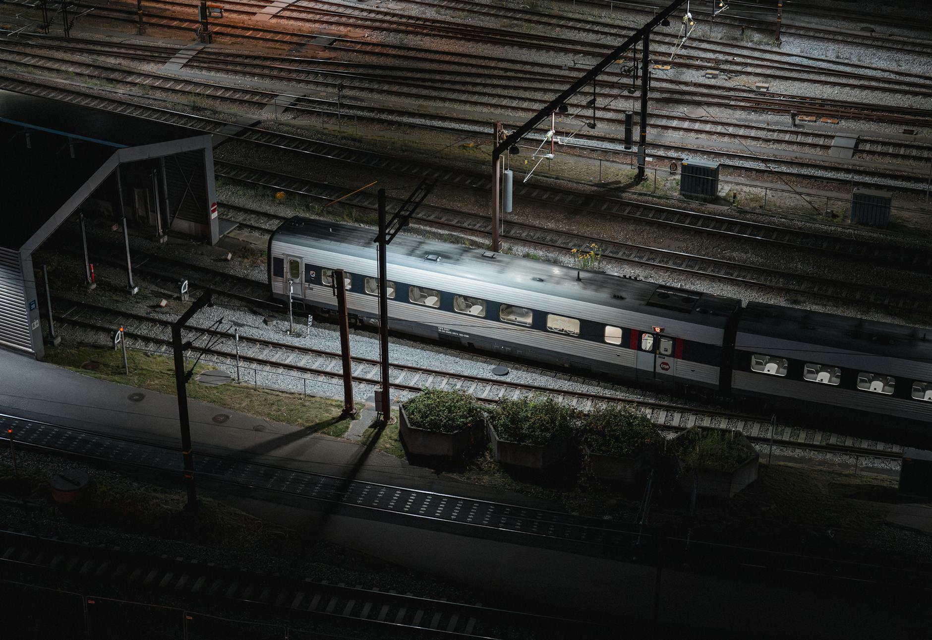 Aerial night view of a train on tracks in Copenhagen, Denmark.
