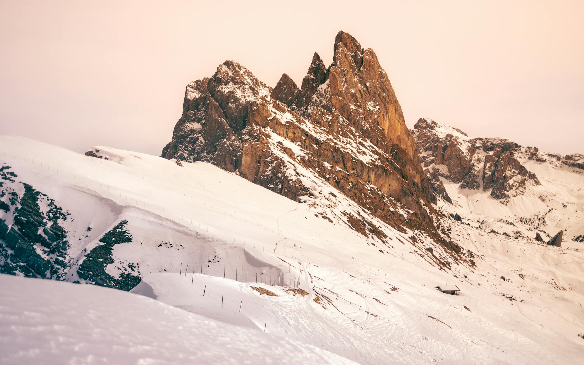 Majestic snow-covered mountains at sunset creating a breathtaking winter landscape.
