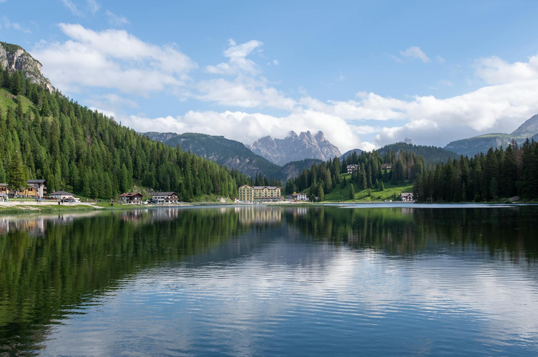 Beautiful view of Lake Misurina with clear reflections of the Dolomite Mountains in Veneto, Italy.